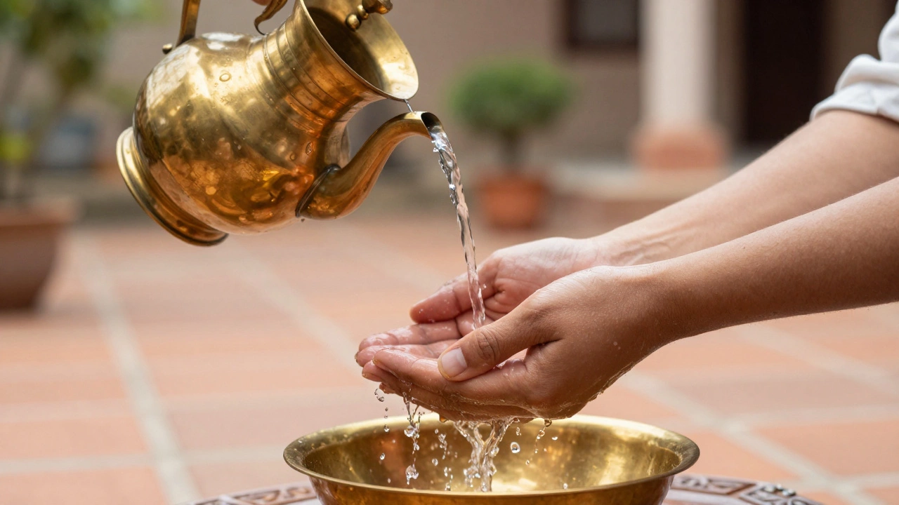 Water being poured from a brass pitcher over hands in a traditional washing ritual